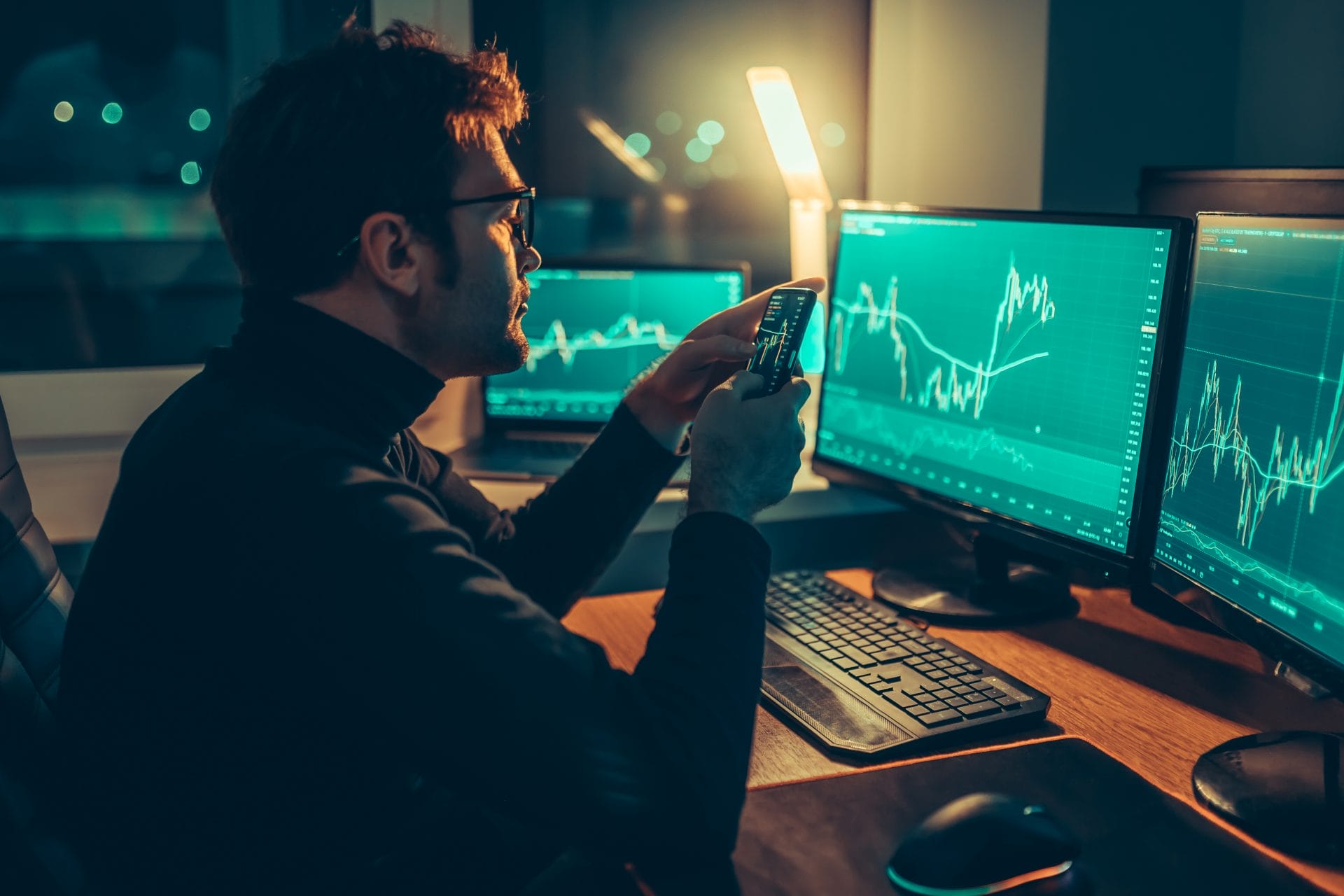 Nighttime Finance A Guy Analyzing Market Trends on a Mobile Device