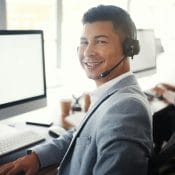 Call center computer, portrait consultant and man telemarketing sales on contact us CRM or telecom