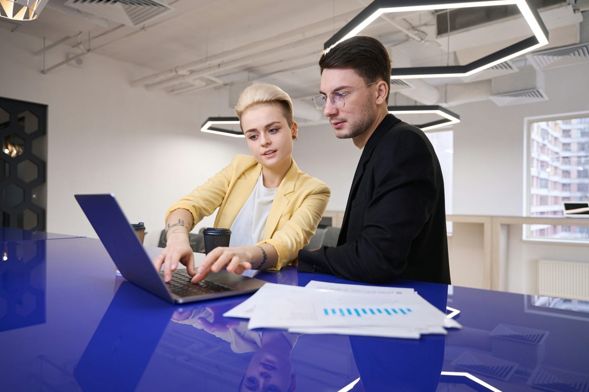 Man and woman developing software on laptop