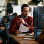 Software engineer using computer while working at IT office.