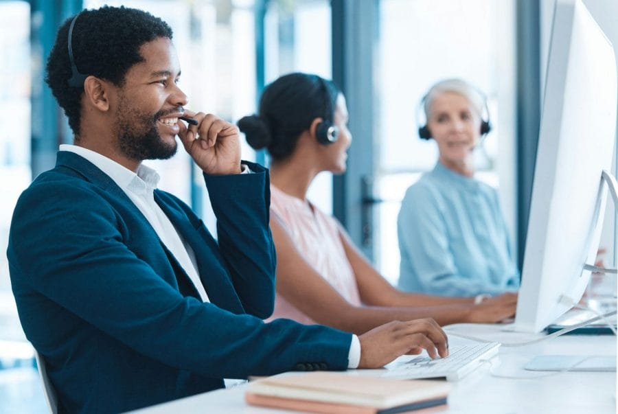 Support, consulting and a black man and woman in call center with headset and computer, help in cus