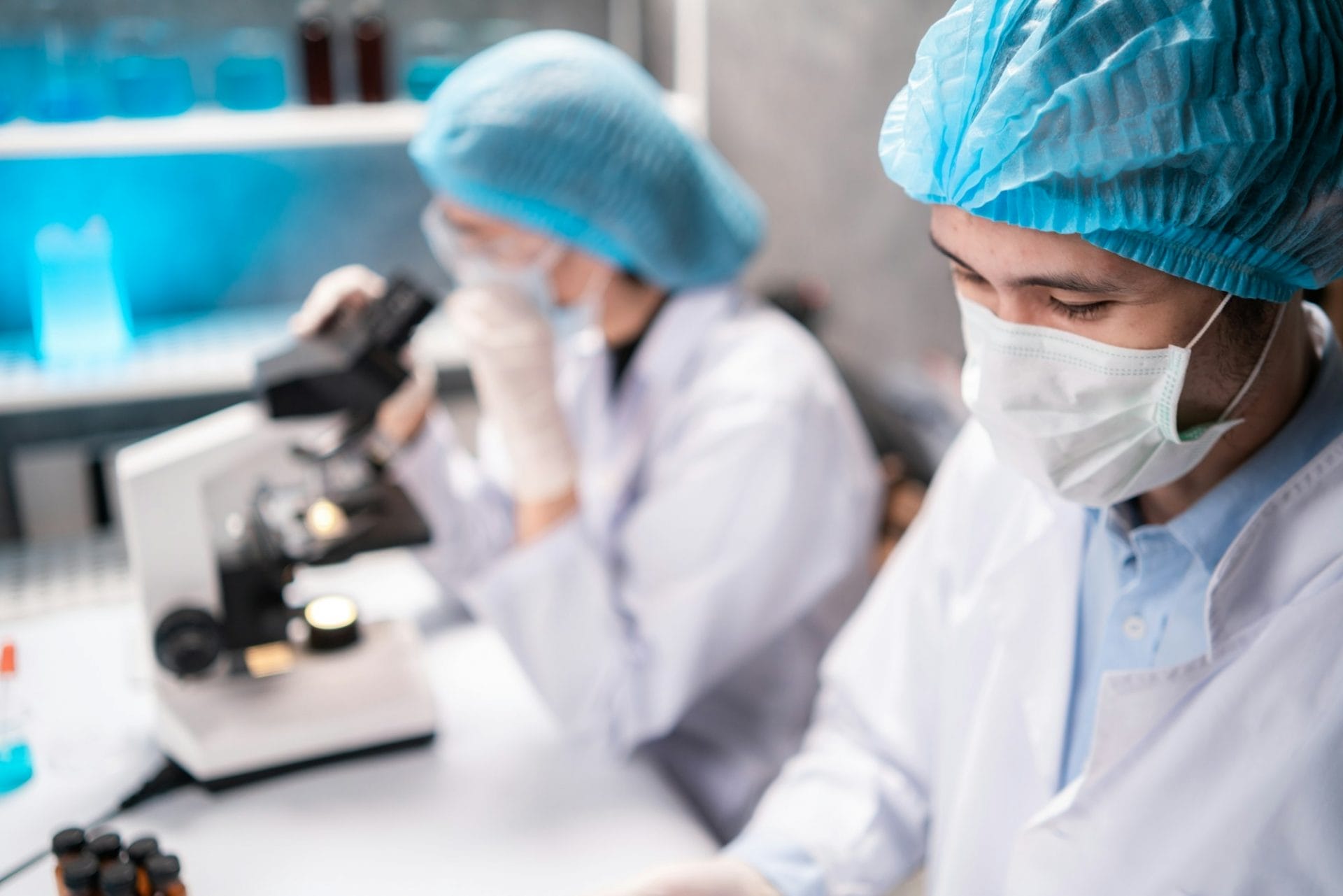 Medical healthcare researcher and scientist writing experiment detail on paper in clipboard