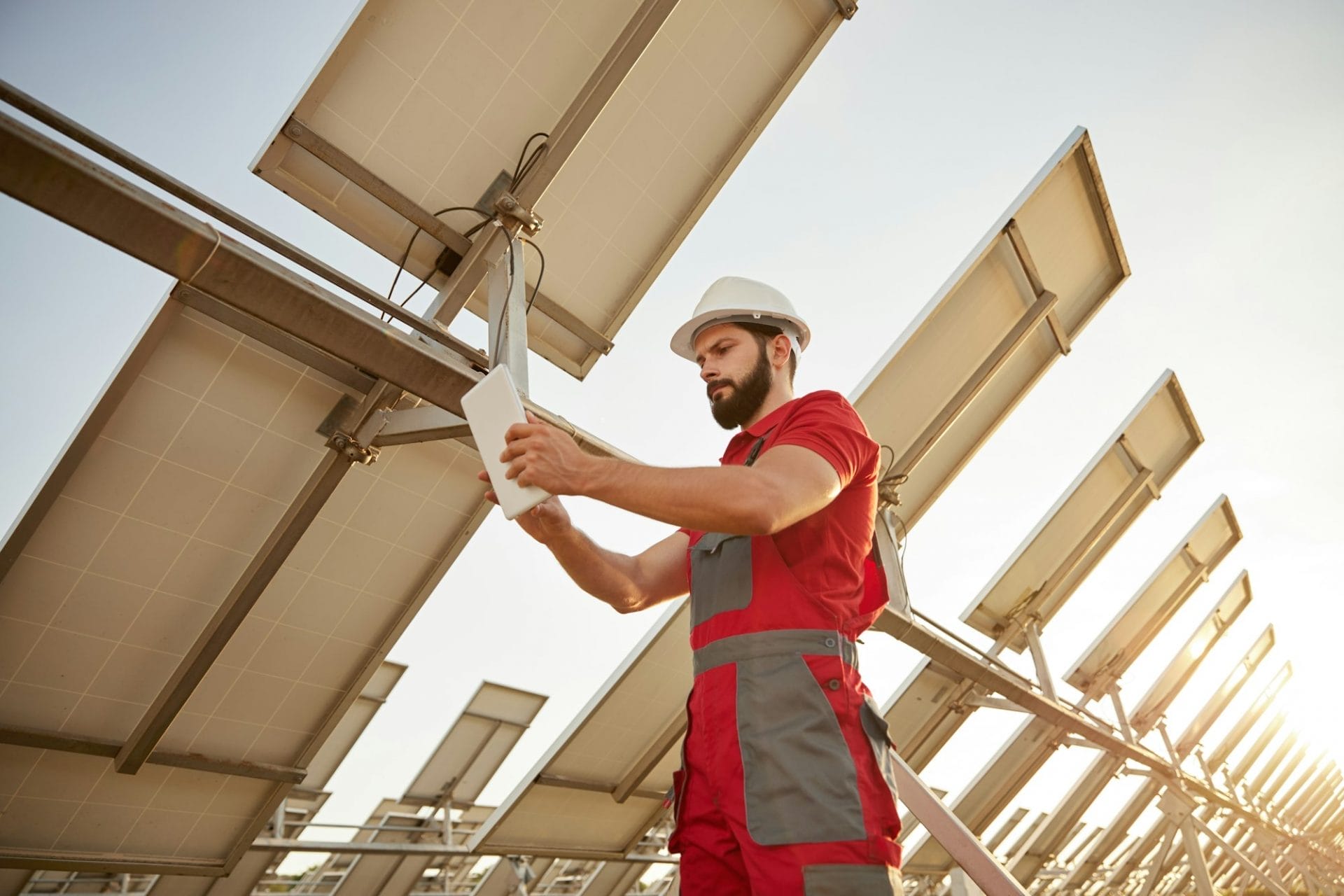 Technician working in field with solar batteries