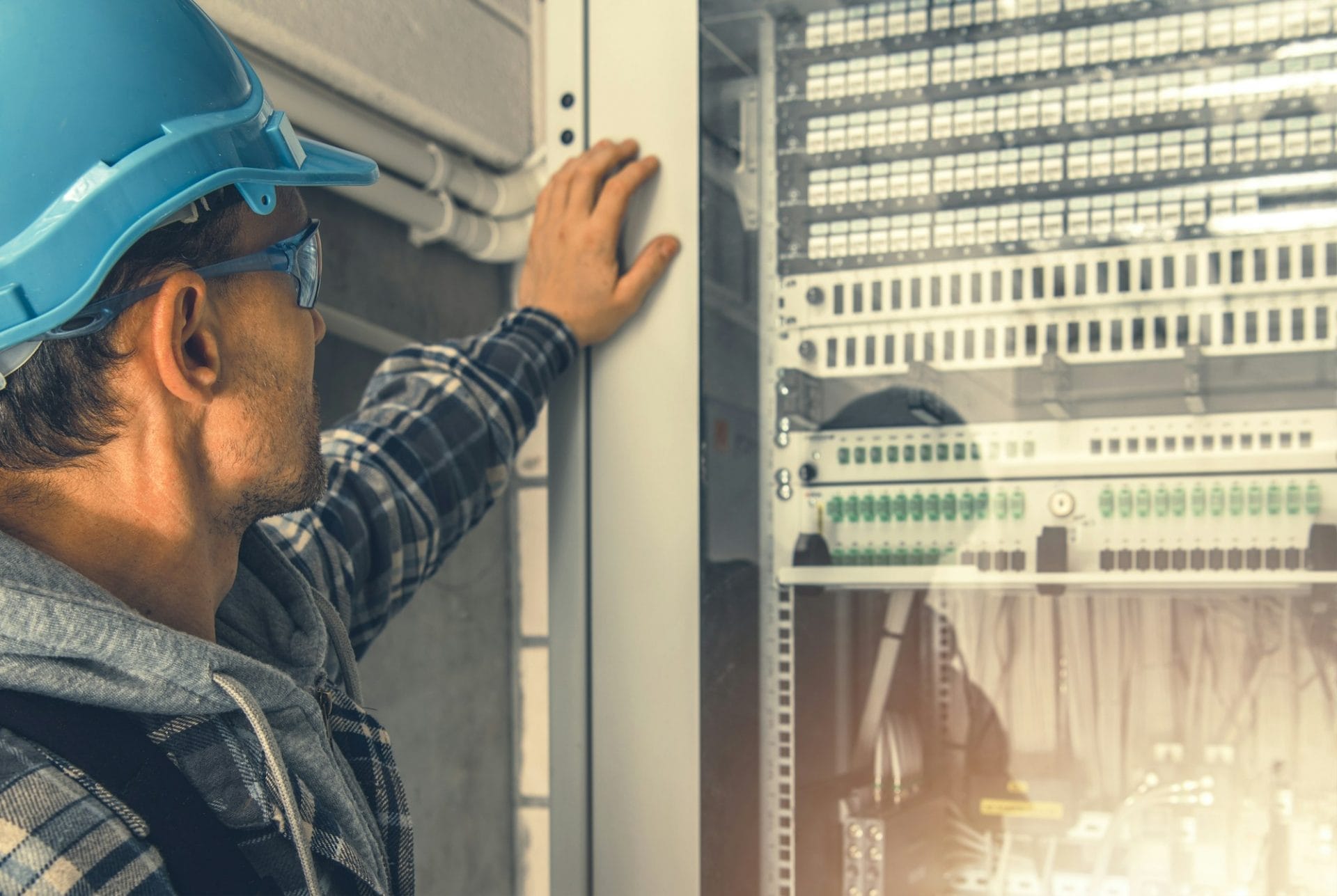 Telecommunication Technician Looking Inside Servers Rack