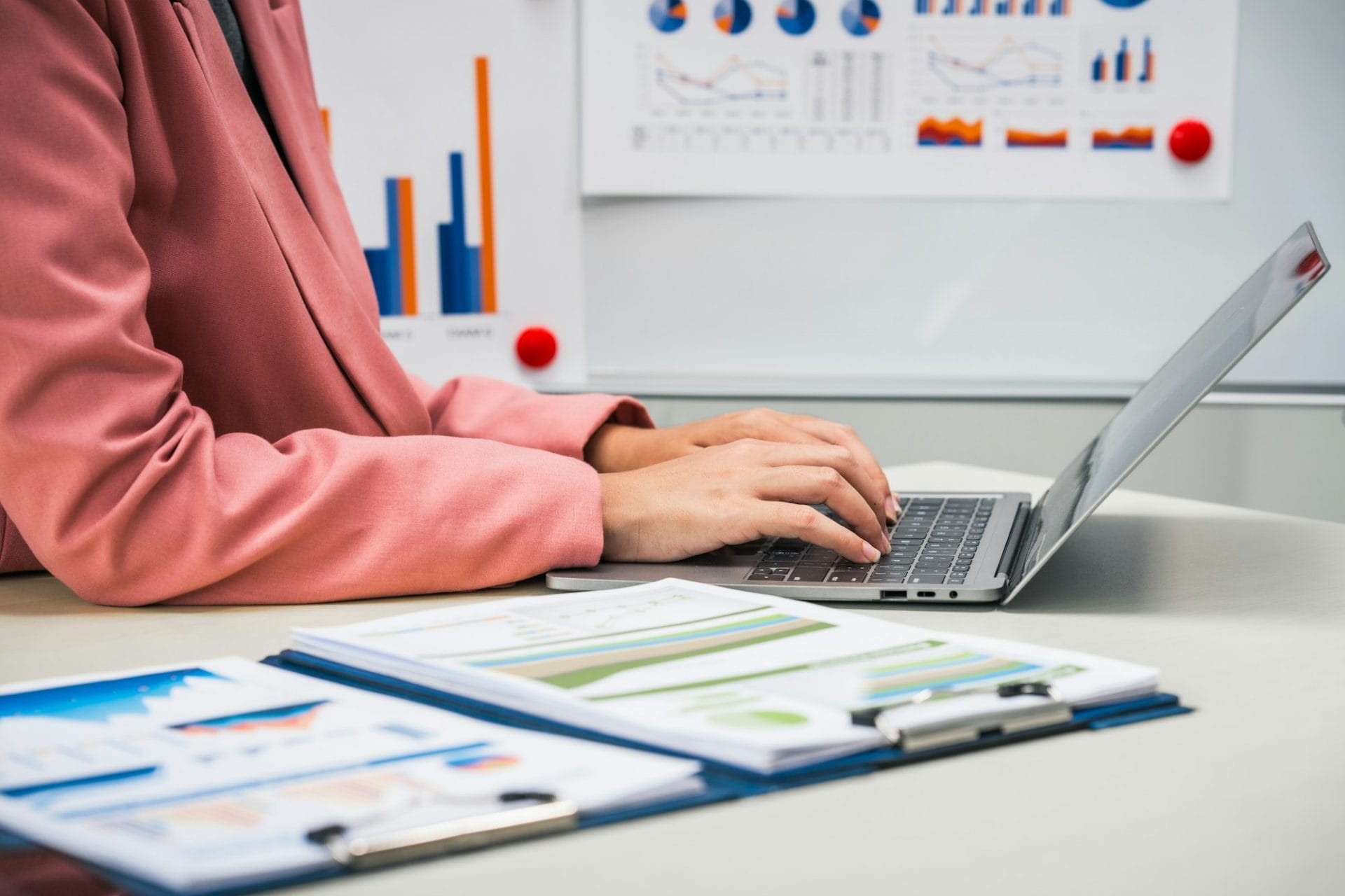 businesswoman works diligently at her desk, reviewing financial documents and analyzing investment