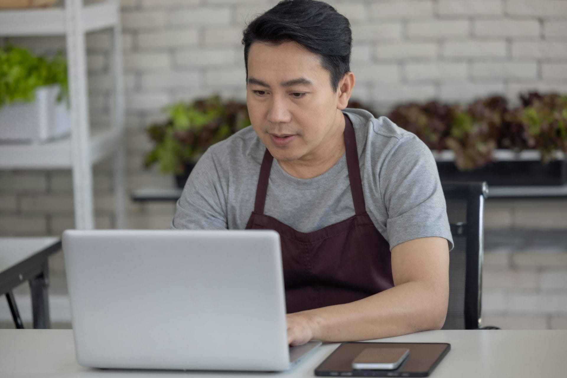 Vegetable Sellers Using Laptop for Inventory Management in Indoor Urban Market