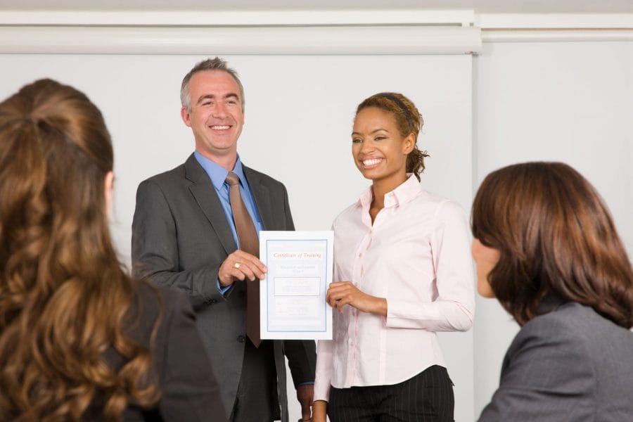 A lecturer handing a certificate to a student